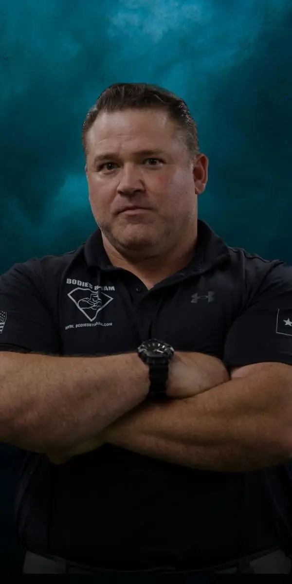 Adam Young, founder of Bodies by Adam, arms crossed